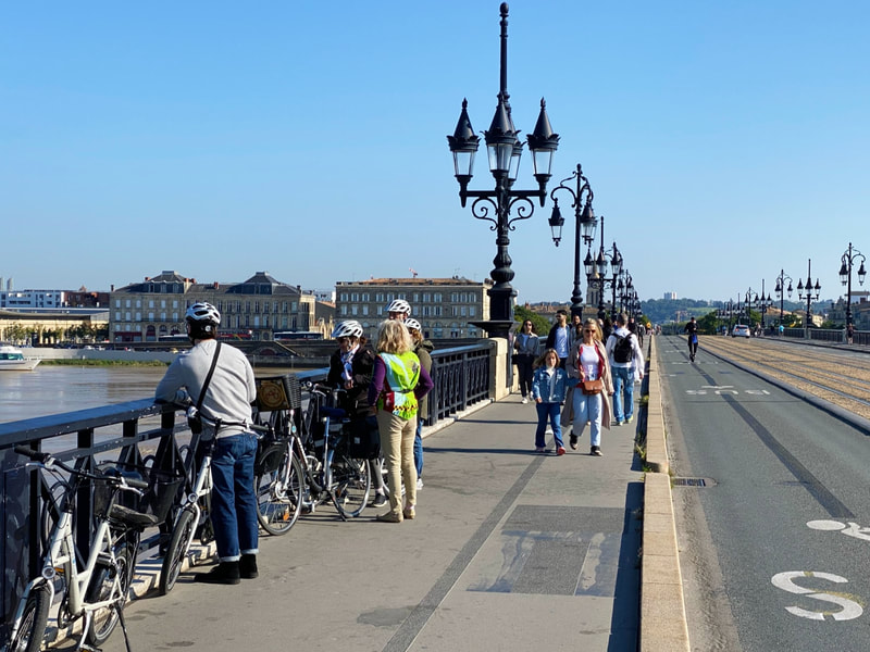 Bordeaux bike tour stopped on the Pont de Pierre bridge
